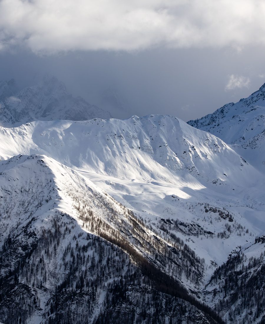 Snow covered peaks in the Alps under heavy cloud